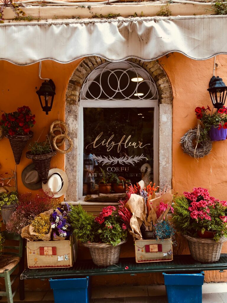 Vibrant floral arrangement outside a quaint flower shop in Corfu. Perfect for urban, cheerful themes.